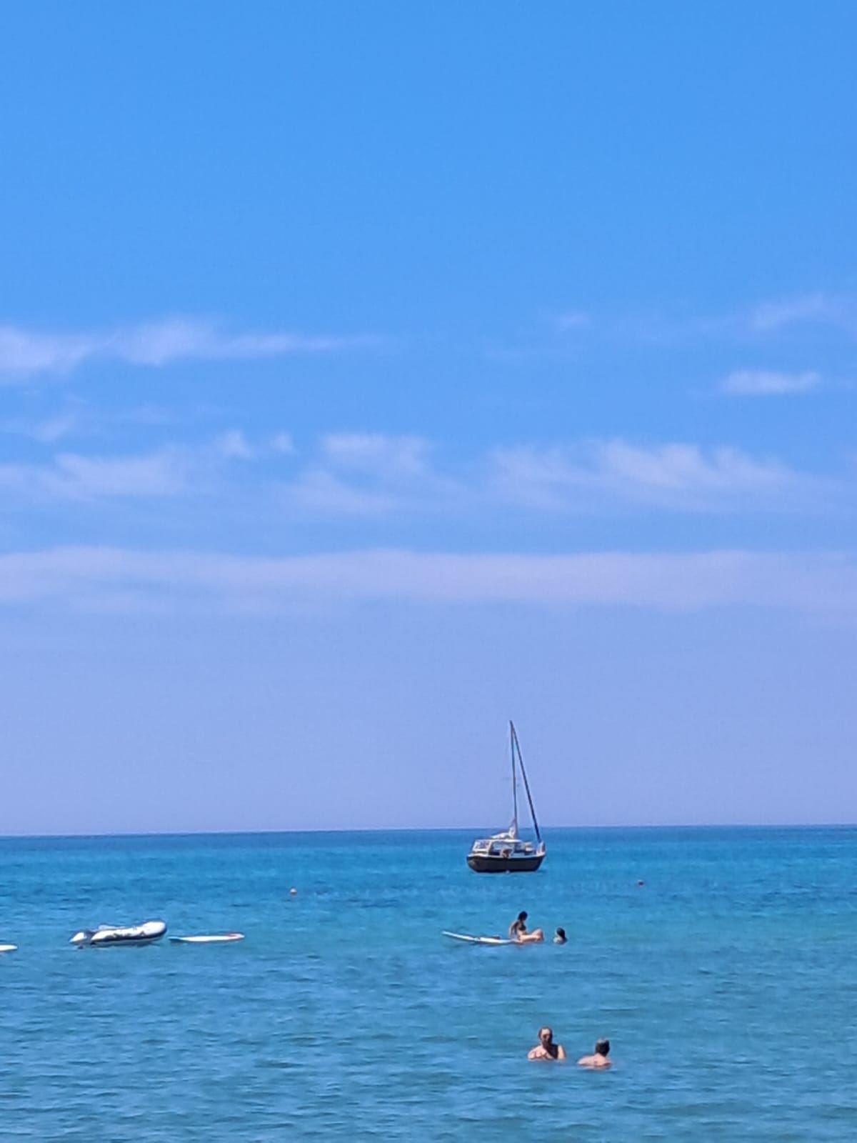 STRIGA anchored offshore while guests swim in the turquoise water